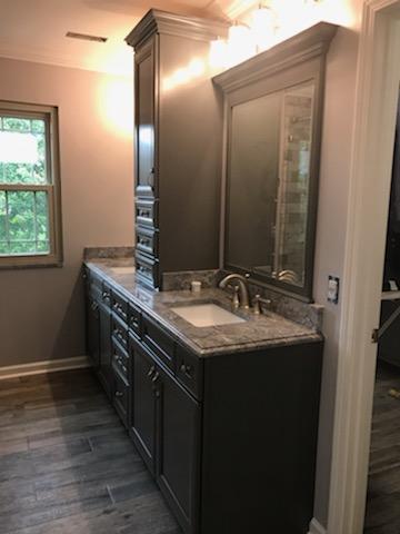 New sink in bathroom with cabinets